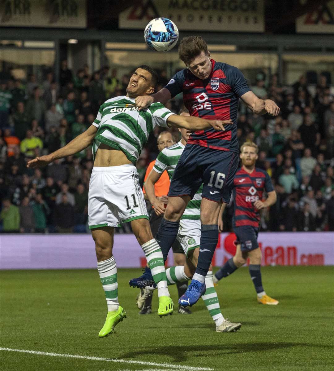 Ross County's George Harmon wins a high ball from Celtic's Liel Abada.