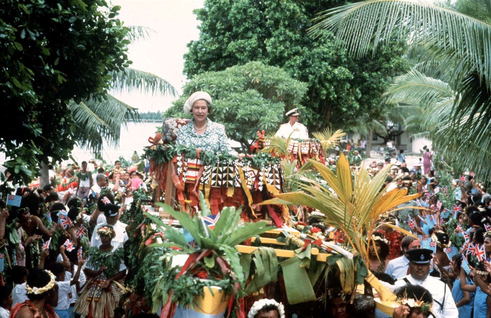 The Queen is carried shoulder-high in a canoe by islanders during a tour to Tuvalu in 1982 (PA)