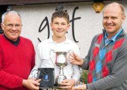 Sandy Park (left), convener of Highland Council and Murray Urquhart, PGA professional at Spey Valley, presents Nairn Academy’s Rory Asher with his prize after winning the first handicap section in the boys competition.