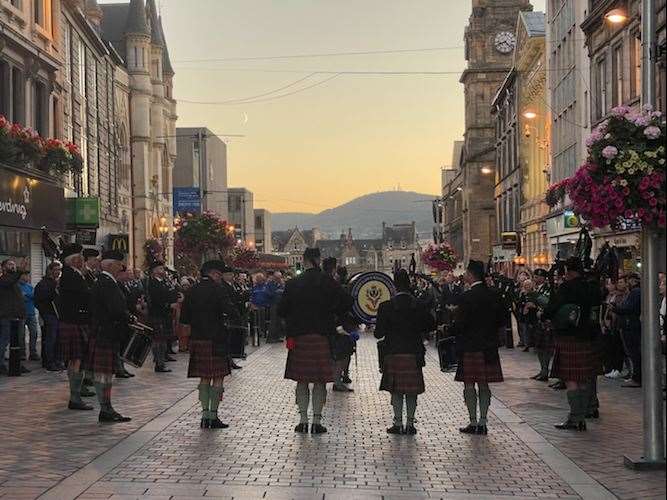 The pipes and drums of the Queen's Own Highlanders Association Pipes and Drums perform at sunset on Inverness High Street on the eve of the competitions. Picture: Meg Fairrie