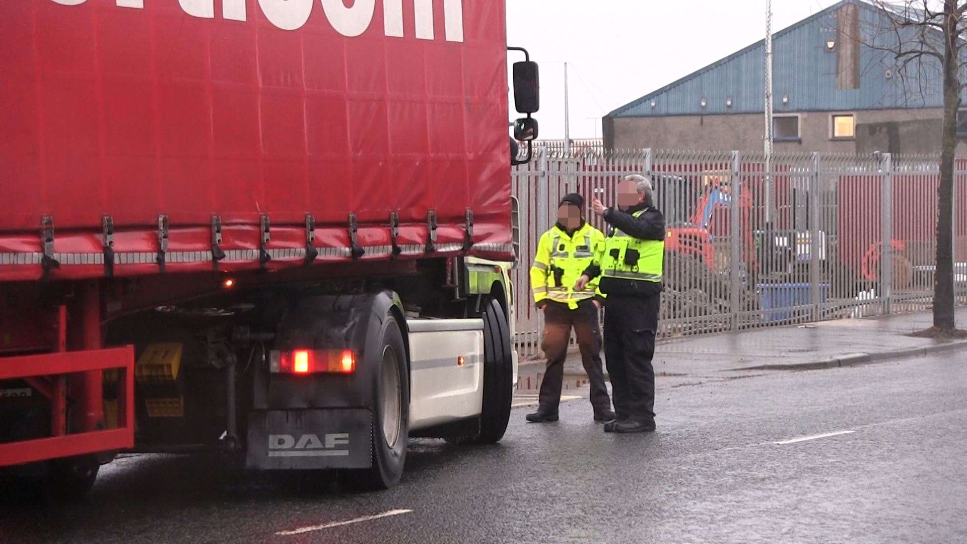 Border Force officers redirect a lorry driver at new checking facilities in Belfast after they were suspended on Monday night (David Young/PA)