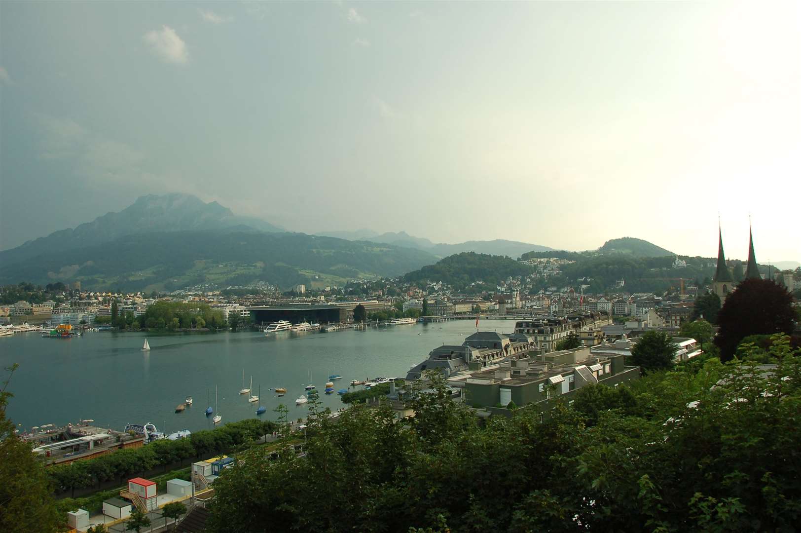 Luzern at sunset, curving round the end of the lake, with the bulk of the Pilatus mountain as a background.