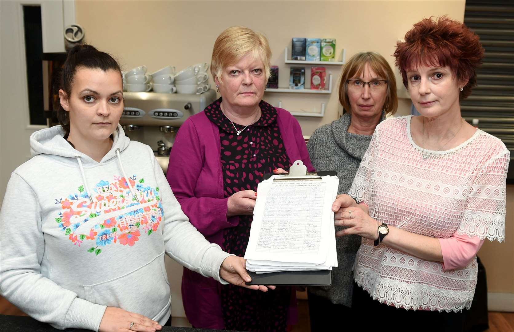 Café staff Rochelle MacNeil, Sharron Cameron, Sandra Banford and Linda Lister with a 1300-name petition calling for the café to be saved.