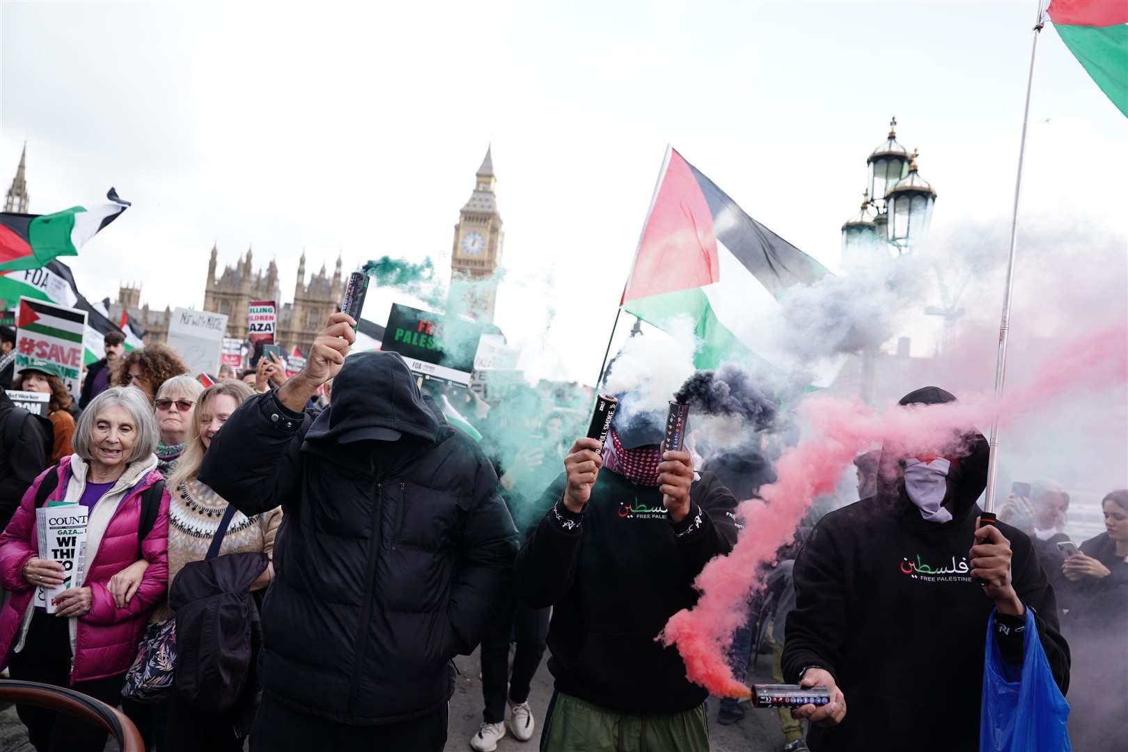 Protesters let off green and red flares (Jordan Pettitt/PA)
