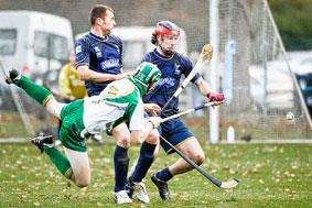 Neil MacDonald and John Barr (both Scotland) stop the flying Tommy Walsh (Ireland) during the shinty/hurling international at the Bught.