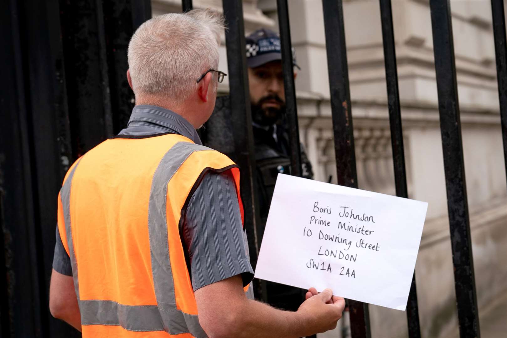 A member of Insulate Britain attempts to hand in a letter for Prime Minister Boris Johnson at 10 Downing Street (PA)