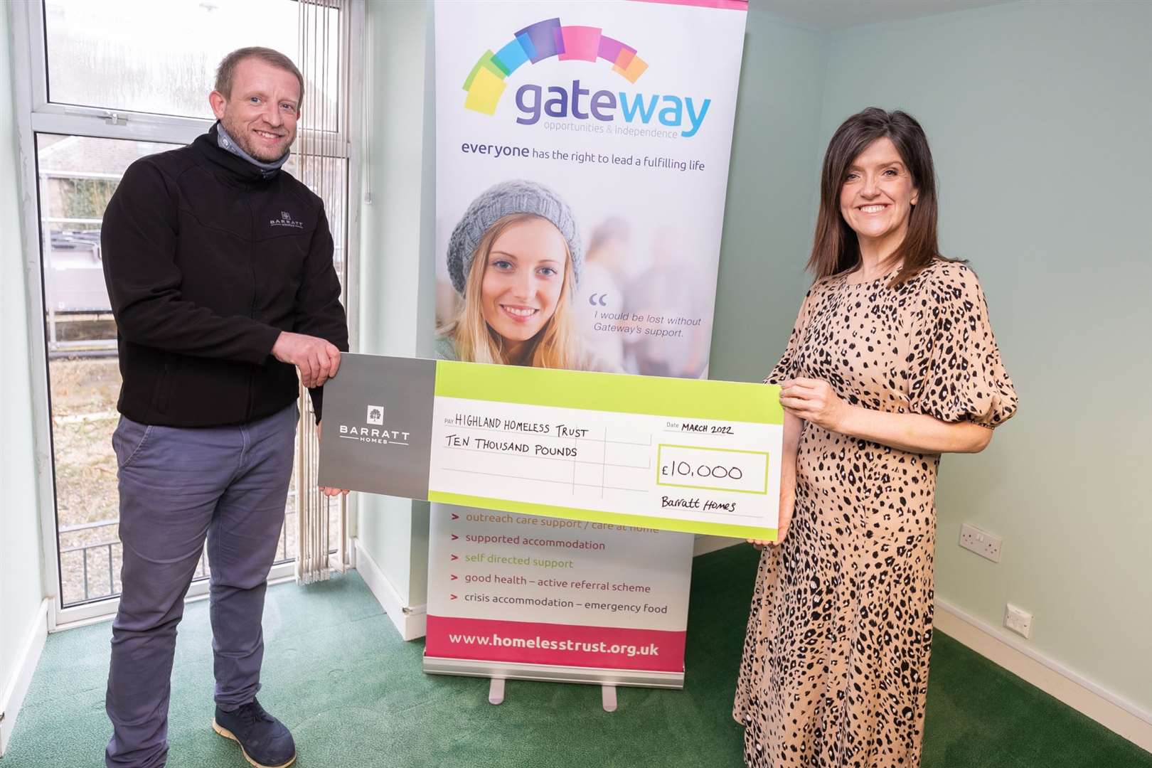 Alan Fraser, Construction manager at Barratt Scotland hands over a £10,000 donation to Clare Netherton of The Highland Homeless Trust Charity in Inverness.