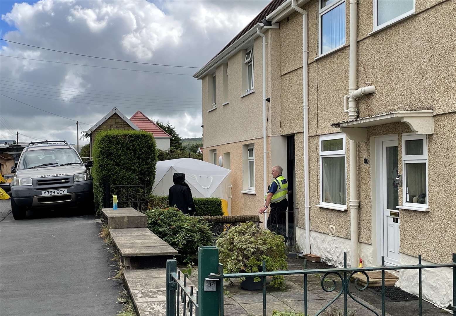 South Wales Police and forensic units at the scene (Bronwen Weatherby/PA)