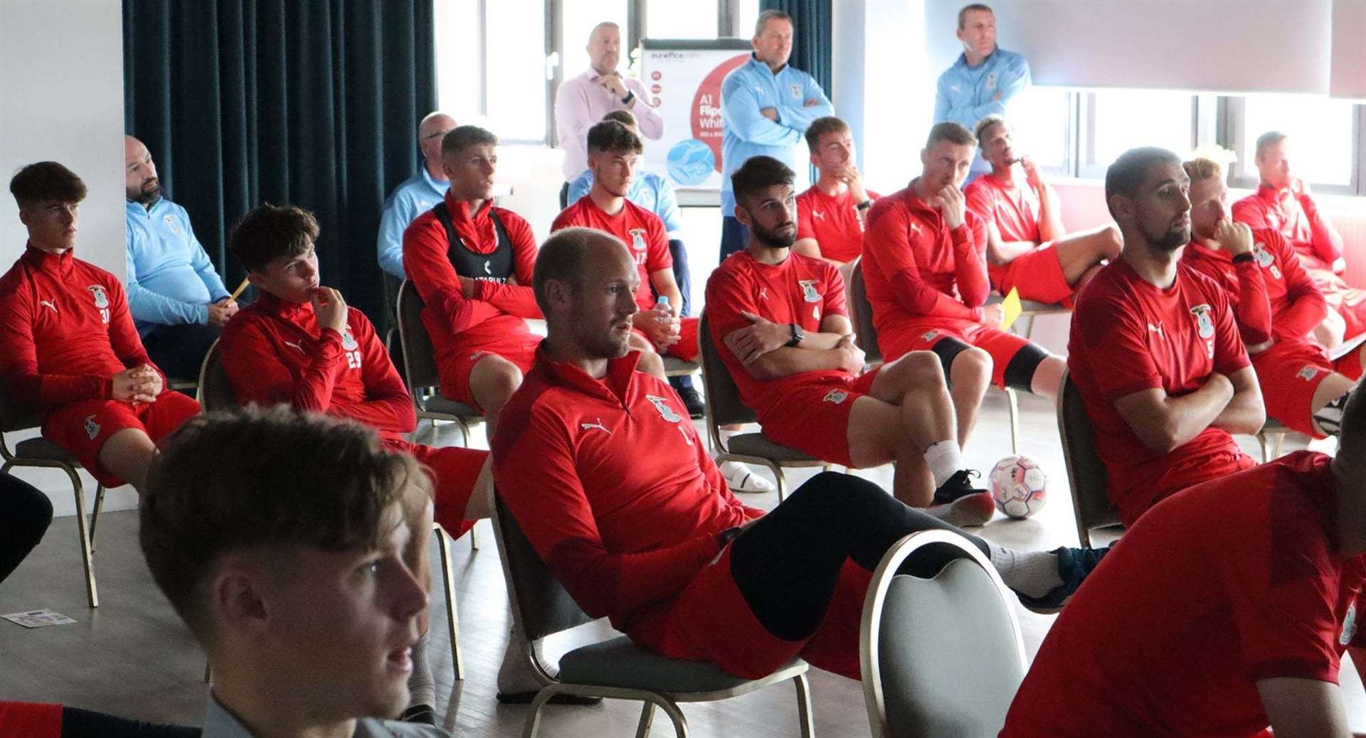 The Caley Thistle squad listen intently to Mikeysline's talk on mental health matters