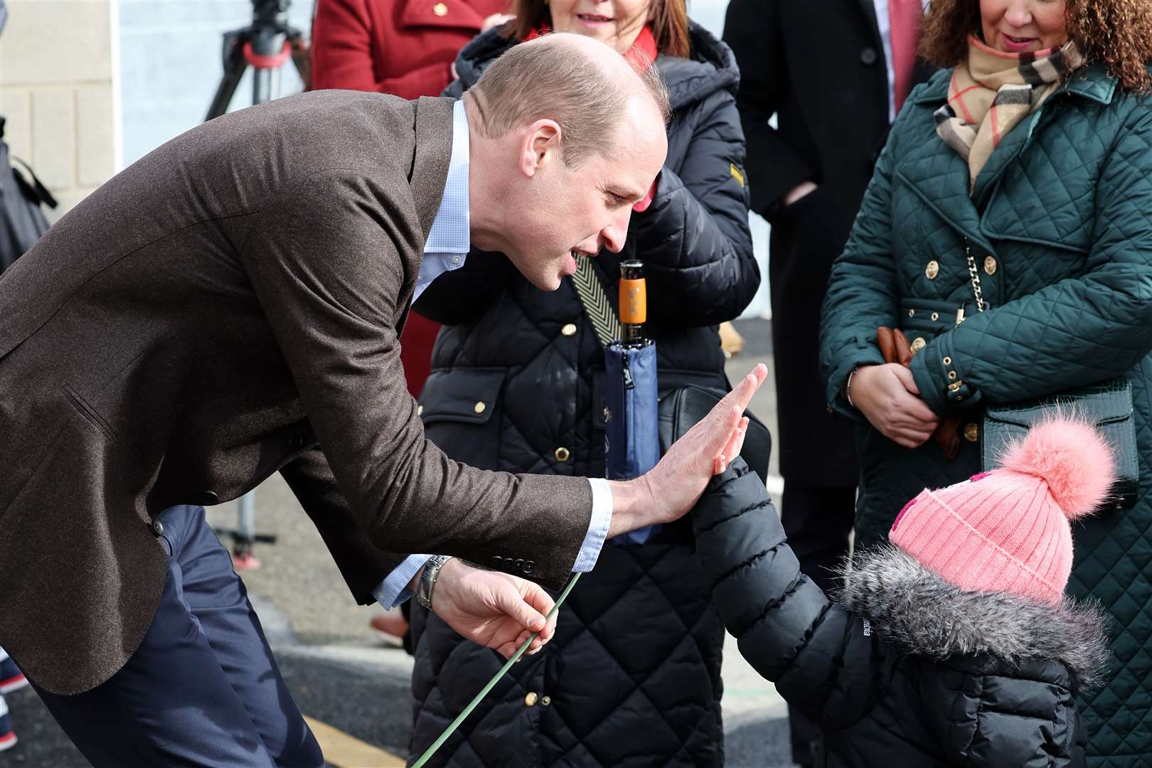 William has a high five with young fan Florence Boyle during his visit to The Turf (Chris Jackson/PA)