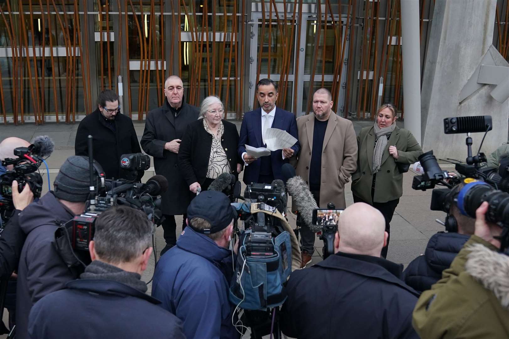 Lawyer Aamer Anwar speaks to the media with Margaret Caldwell (Andrew Milligan/PA)