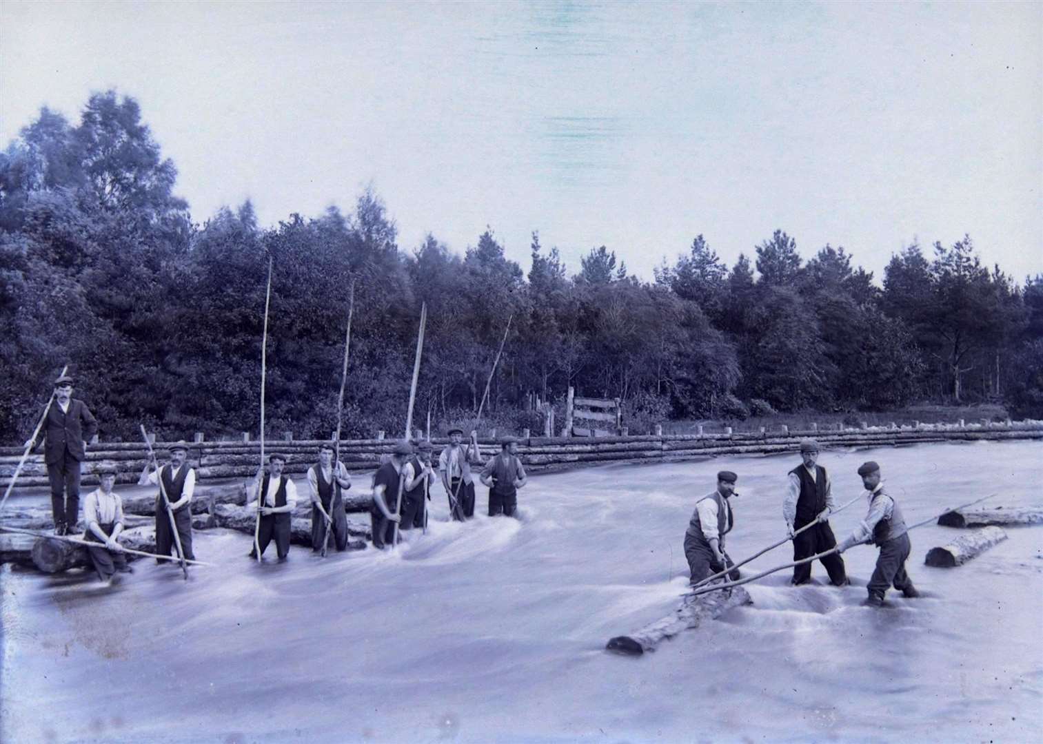 Forest workers shifting wood down the Spey. Picture: Walter Dempster