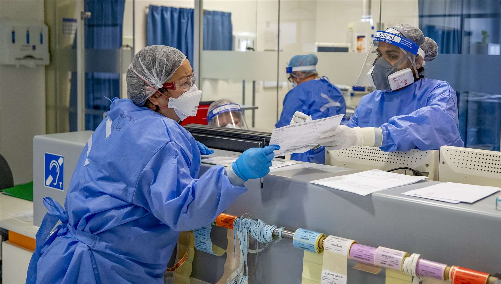 Health workers wearing full personal protective equipment on the intensive care unit (Peter Byrne/PA)