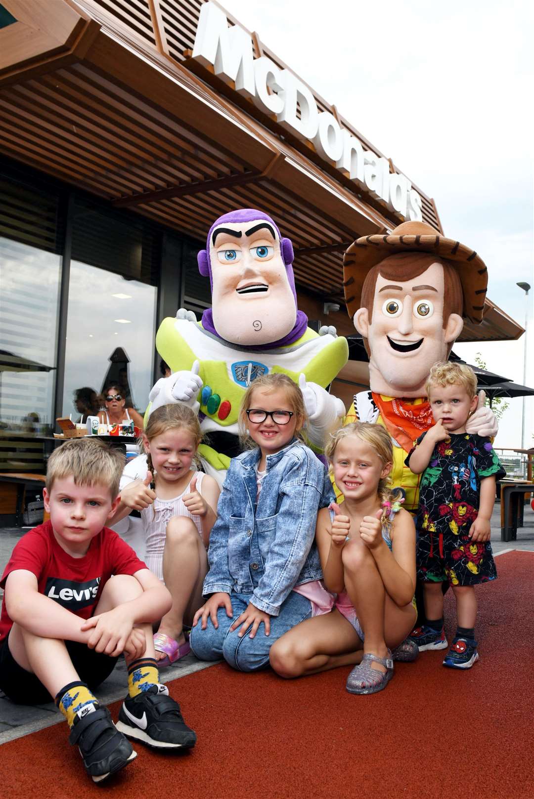 Iain Fyfe as Buzz Lightyear and Susan O'Neill as Woody with children outside McDonalds in Nairn. Picture: James Mackenzie.