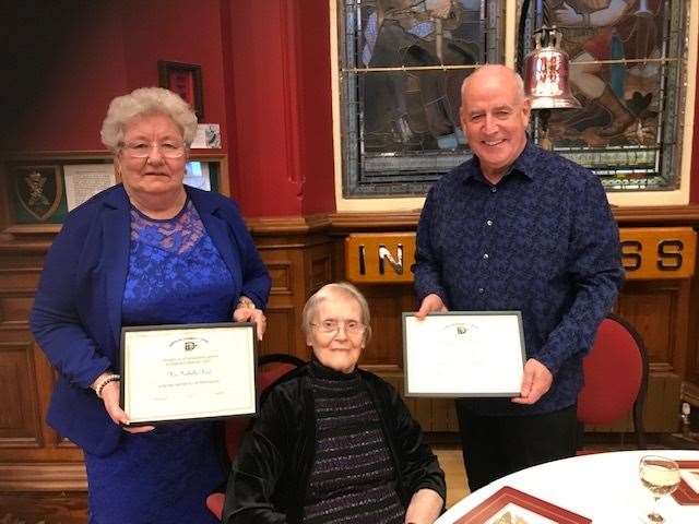 Isobel Reid and Peter Corbett receive their awards from Janet Home.