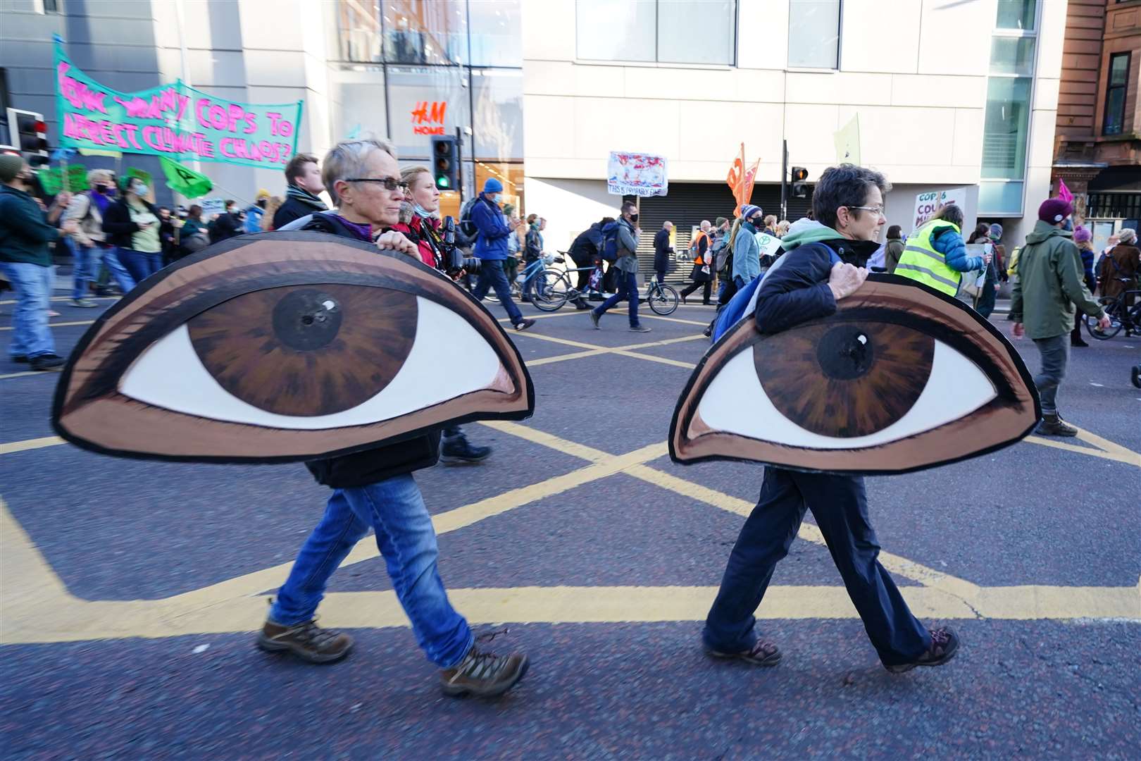 Demonstrators carried two large eyes to suggest the climate group ‘was watching the world leaders’ (Jane Barlow/PA)