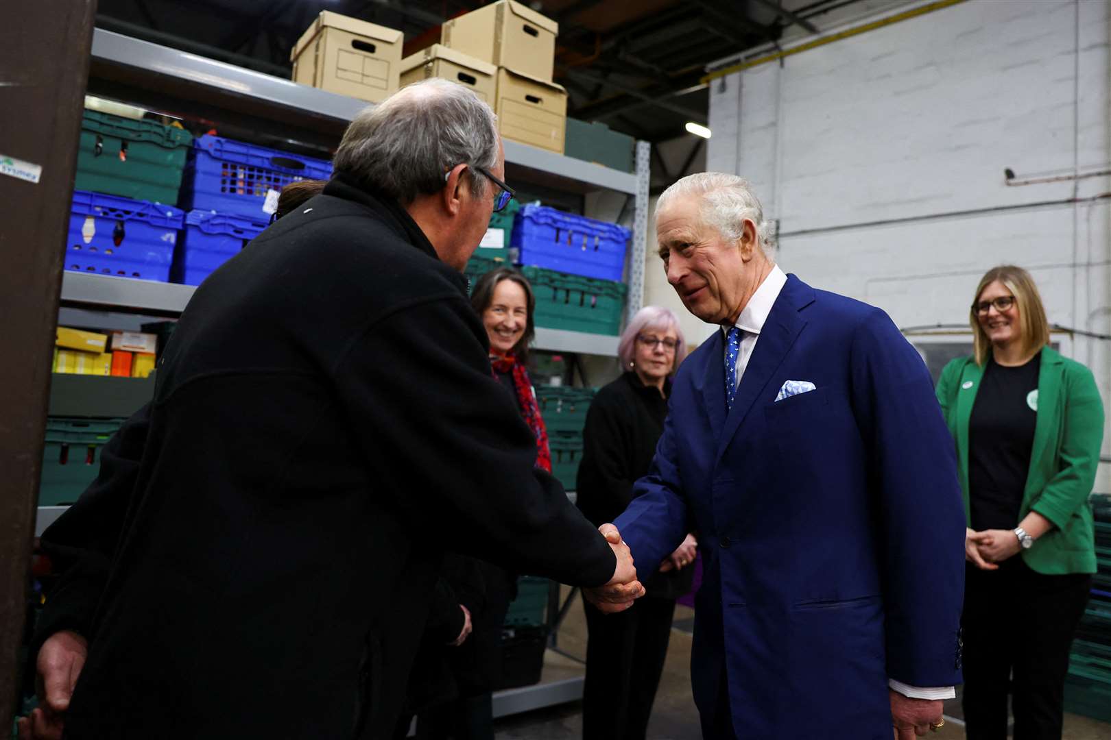 The King speaks with volunteers during a visit to the Milton Keynes food bank (Molly Darlington/PA Wire)