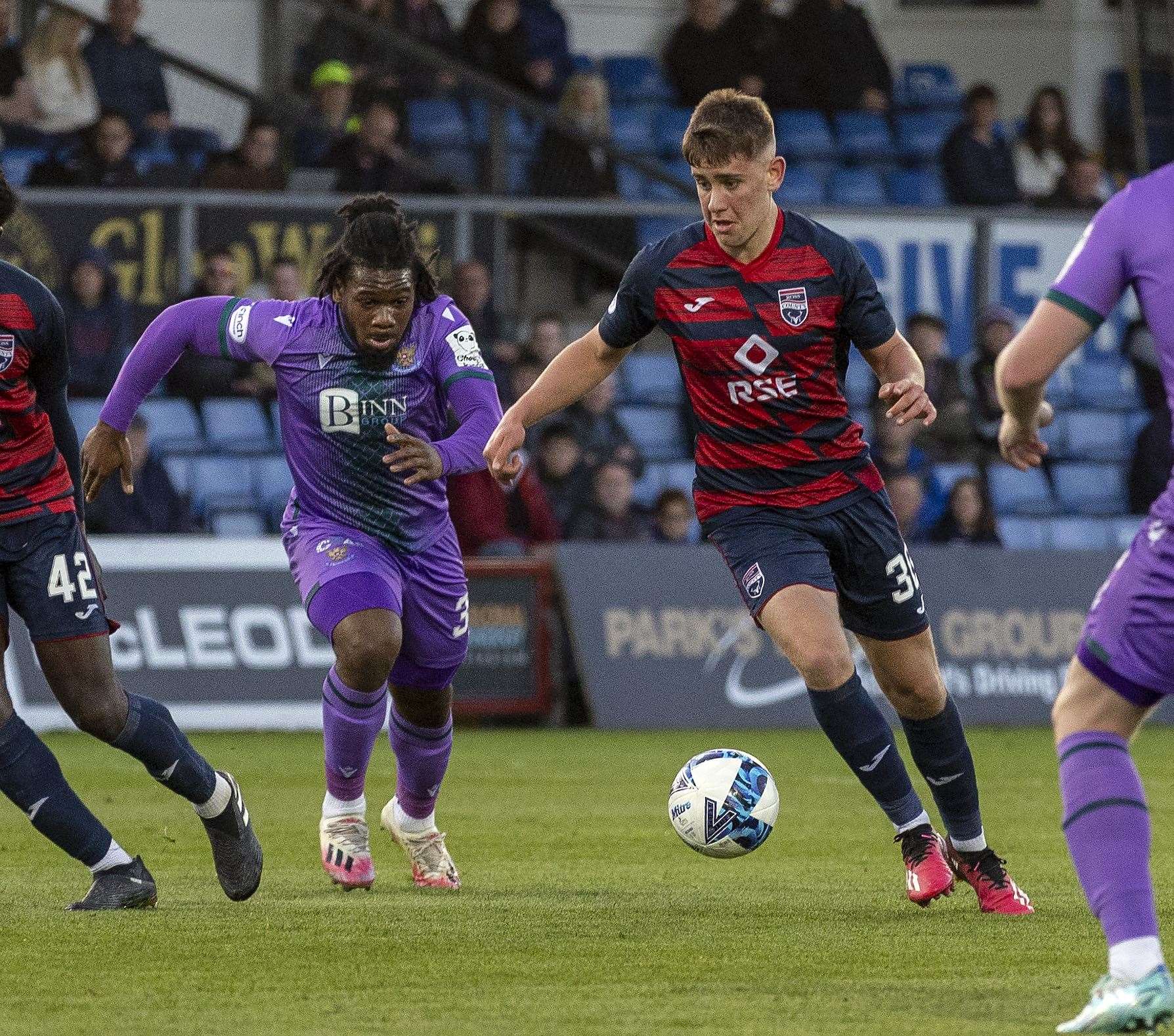 Ross County's Dylan Smith gets past St.Johnstone's Daniel Phillips.