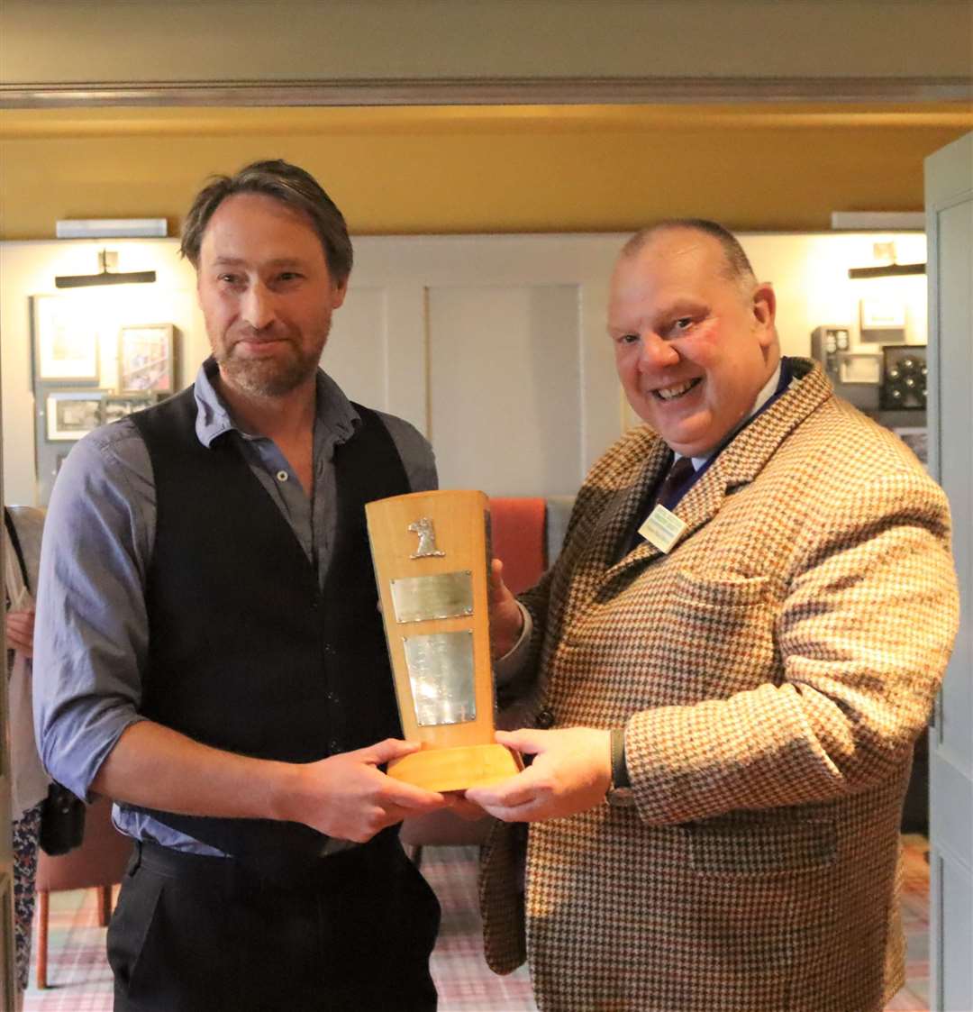 Dr Euan Bowditch (left) receiving the trophy from Simon MacGillivray.