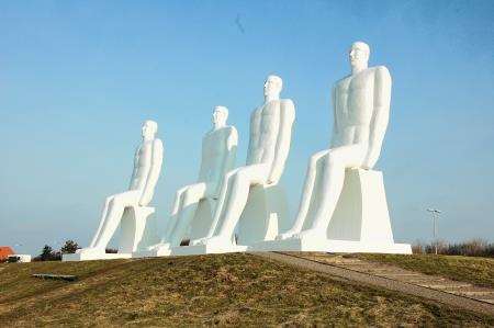 Man meets the sea statues in Esjberg
