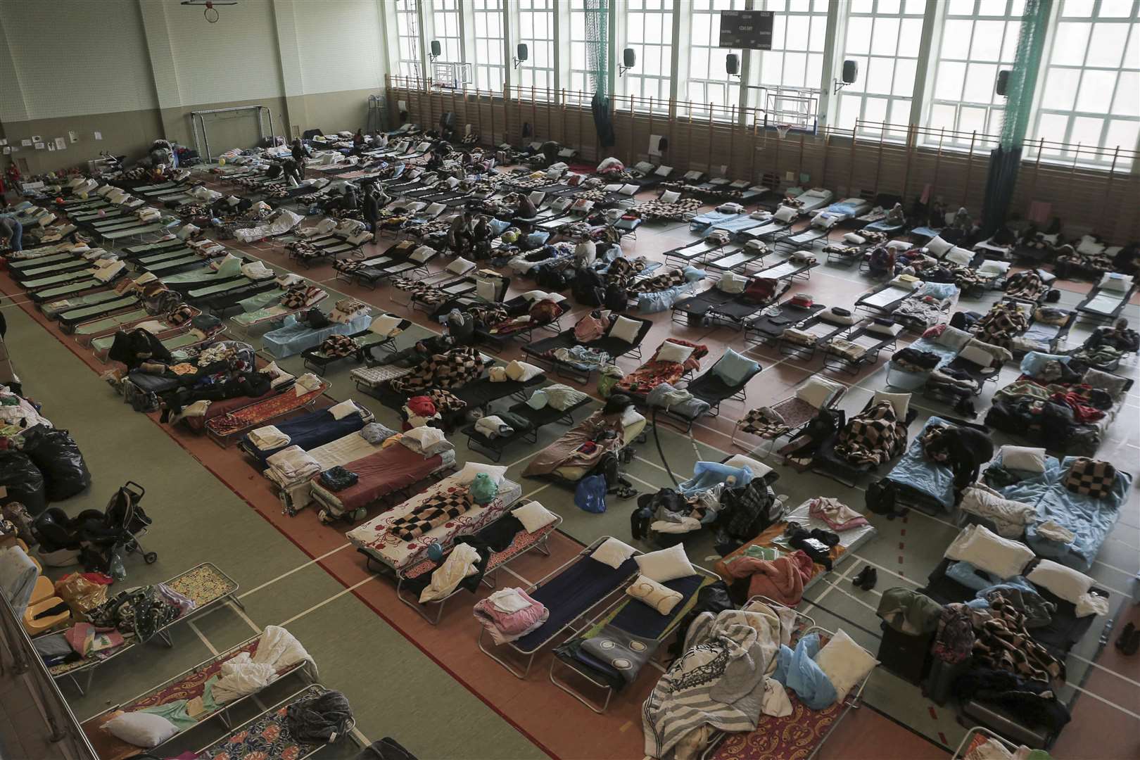 Hundreds of beds are placed inside a sports hall to accommodate Ukrainian refugees fleeing Russian invasion at the border crossing town of Medyka, Poland (Visar Kyreziu/AP)