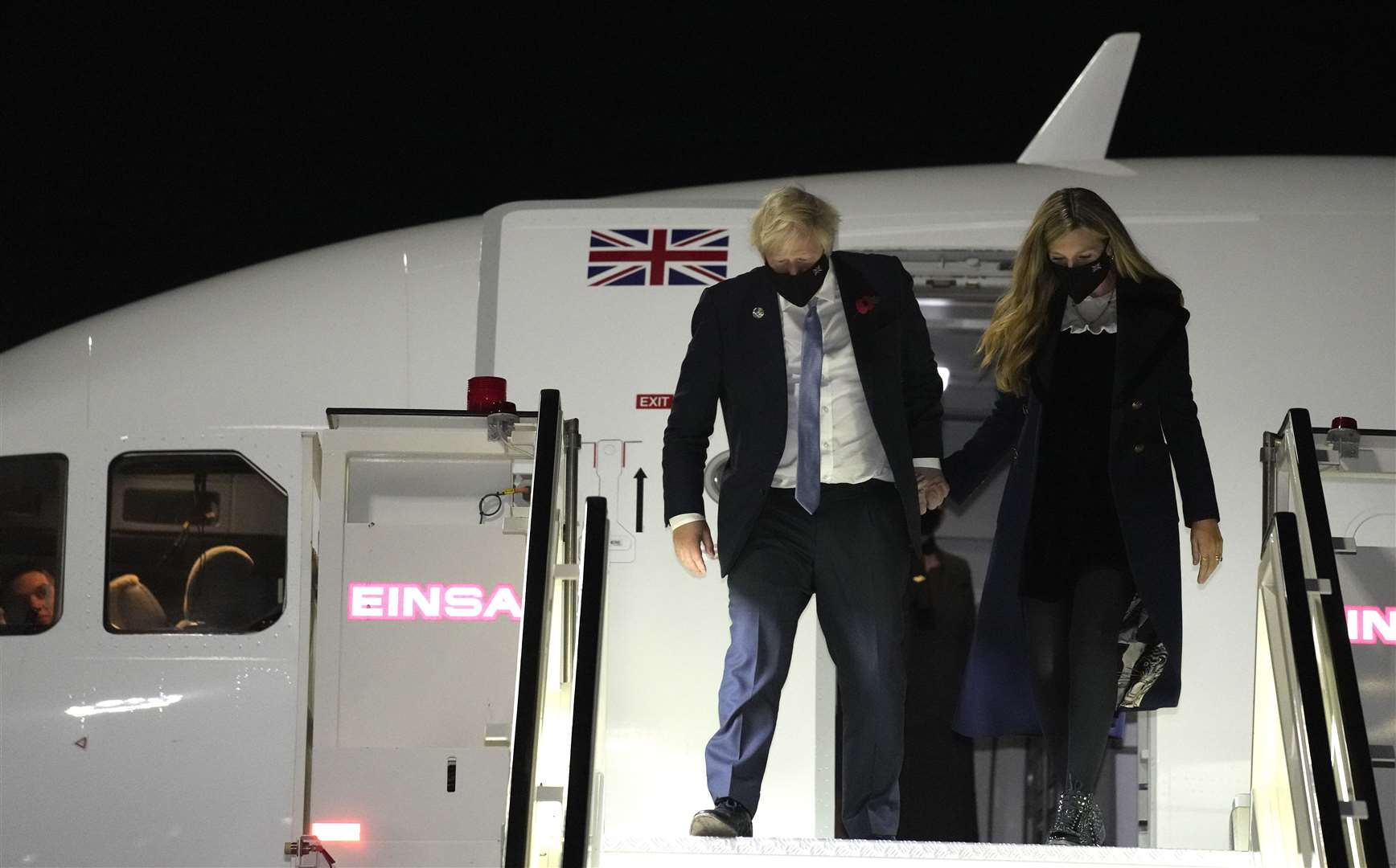 Prime Minister Boris Johnson, pictured with his wife Carrie, spoke with reporters about the French fishing row while travelling to Rome for the G20 (Kirsty Wigglesworth/PA)
