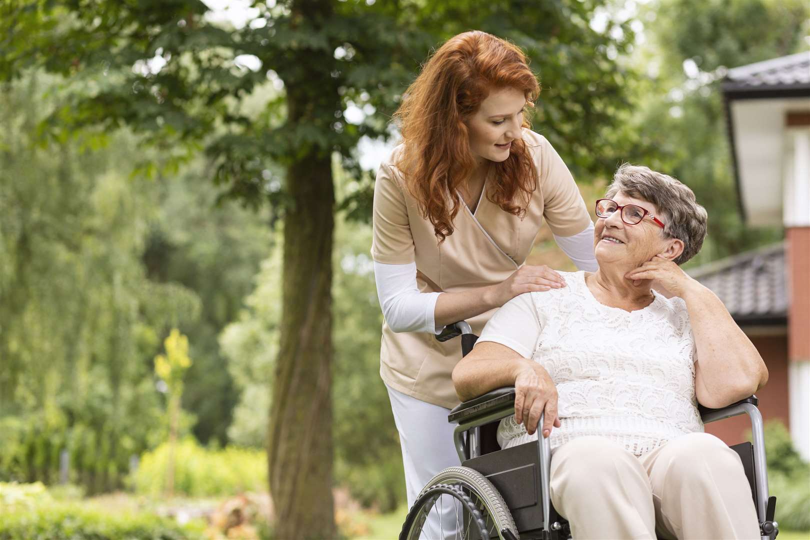 Therapist talking to woman in a wheelchair. Picture: iStock/PA