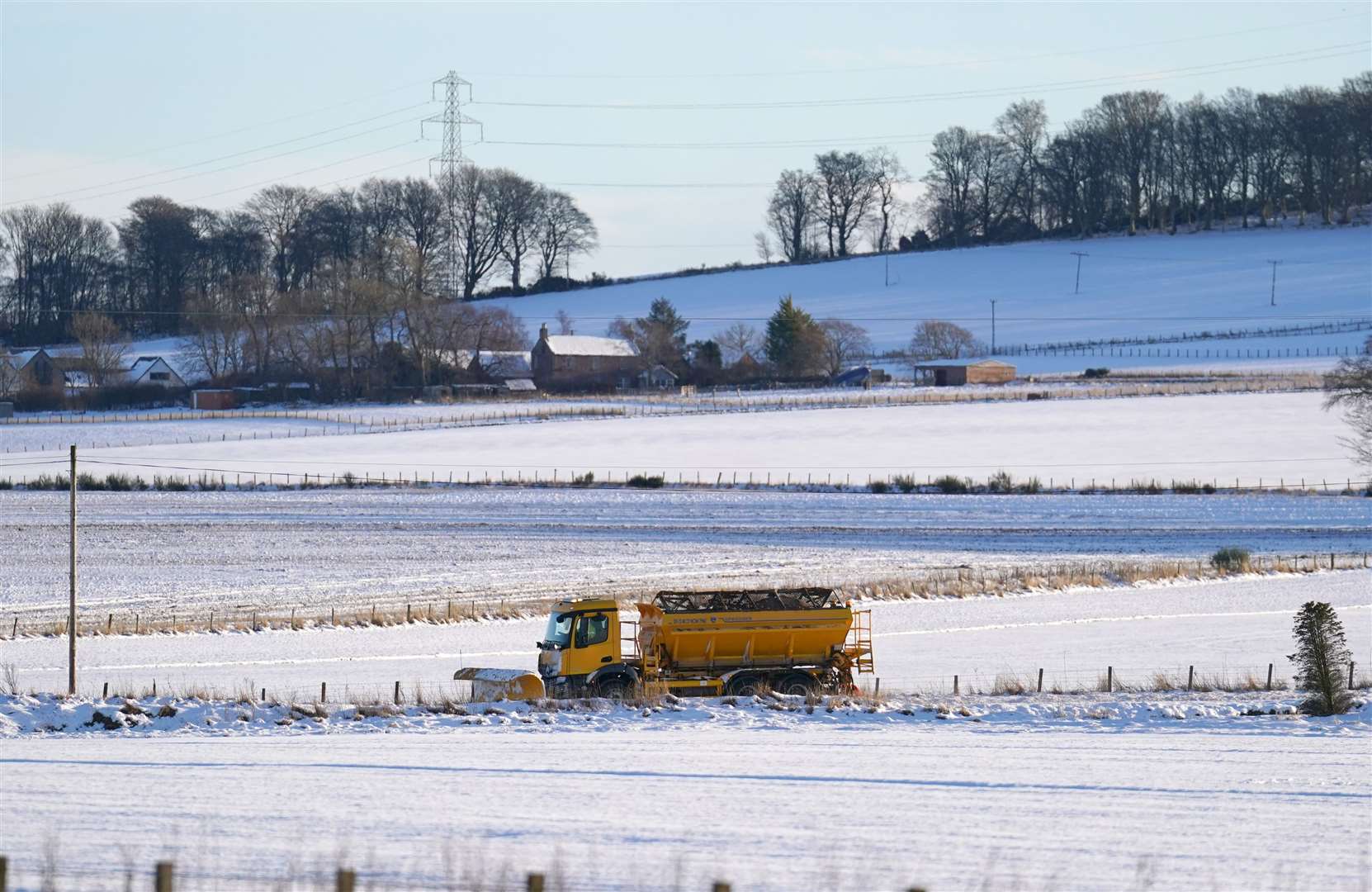 A snow plough clears a road near Fordoun in Aberdeenshire (Andrew Milligan/PA)