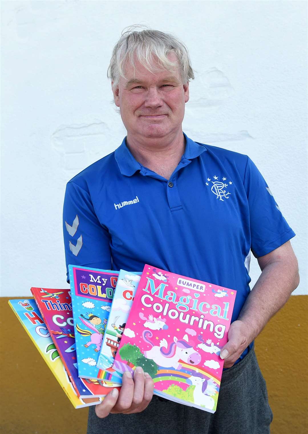 Martin Macdougall is giving away colouring books to help keep children occupied. Picture: Callum Mackay.
