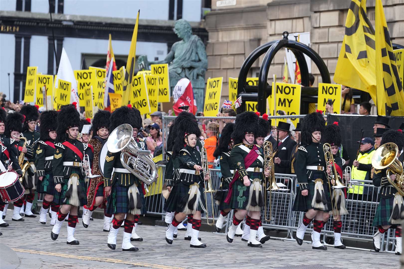 Protesters and royal fans lined the streets to watch the procession (Danny Lawson/PA)
