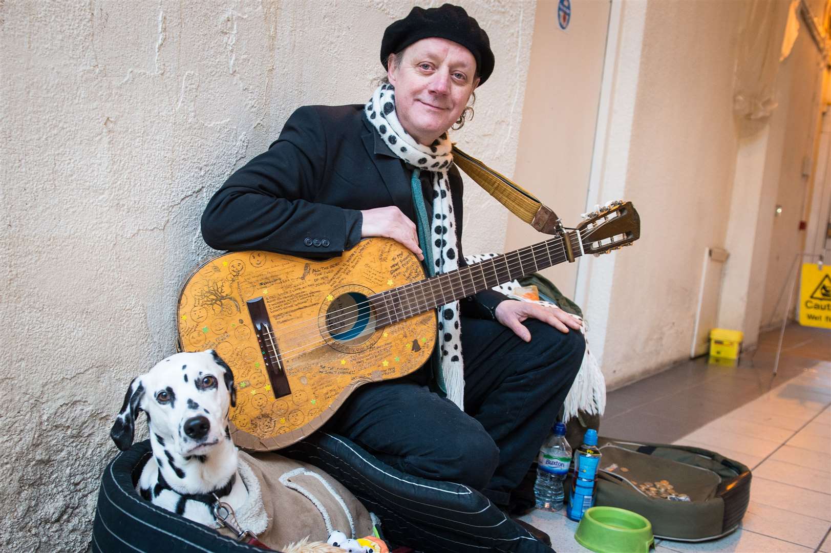 John Casey busking in the Victorian Market, Inverness, with his faithful companion Emily.