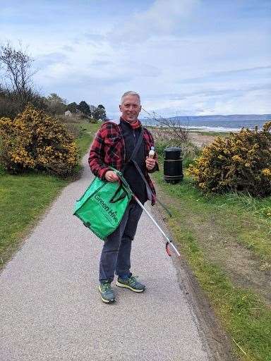 Neil Mapes on a clean up at Nairn beach.