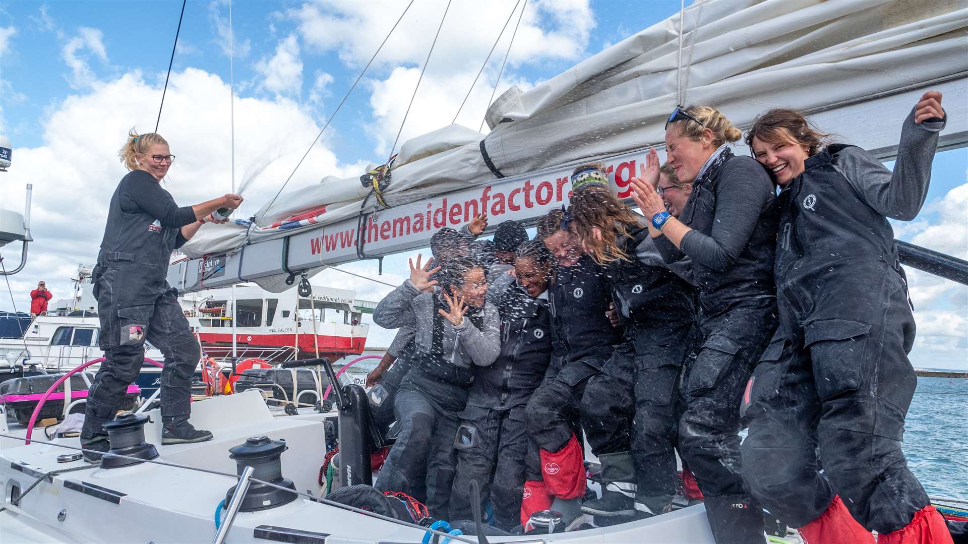 The crew celebrate their arrival at the Isle of Wight (Kaia Bint Savage/The Maiden Factor/PA)