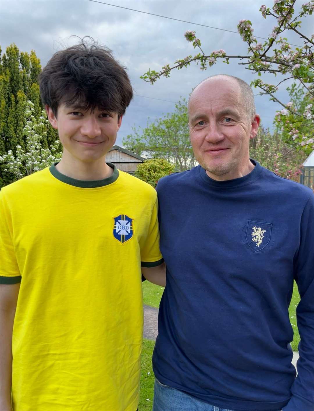 Hector sports the new Scotland shirt designed to mark the 150th anniversary. Michael wears another TOFFS classic, the Brazil top. Picture: Grace Mackenzie